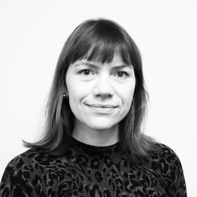 Julia Petretta has shoulder length hair with a fringe and is wearing an animal print top.